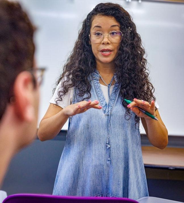 a faculty member lectures in a classroom